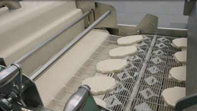 Adjustable scrapers, smart air knives and an innovative batter retention plate help processors maintain coating accuracy with less operator intervention. Source: GEA